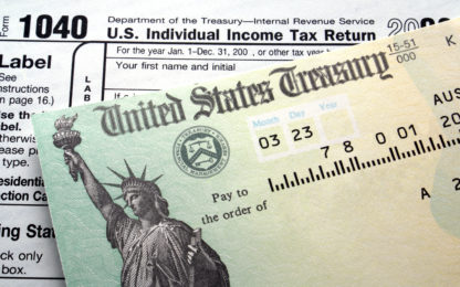 Tax return check on 1040 form background. Photo from Alpha Media Portland OR