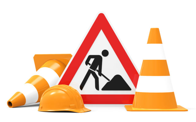 Under construction, road sign, traffic cones and safety helmet, isolated on white background 3D rendering. Photo from Alpha Media USA Portland OR