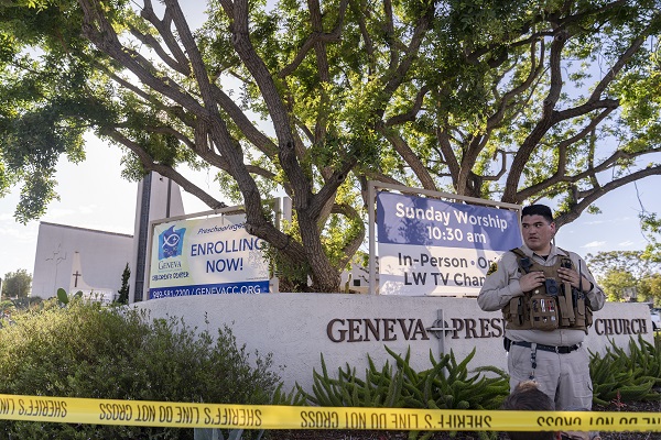 An Orange County Sheriff's Department officer guards the grounds at Geneva Presbyterian Church in Laguna Woods, Calif., Sunday, May 15, 2022, after a fatal shooting. (AP Photo/Damian Dovarganes) used locally May 16th 2022 @ap.images 