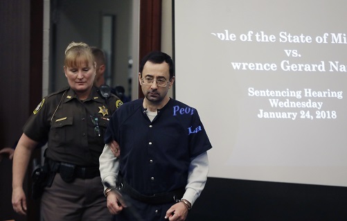 Dr. Larry Nassar is escorted into court during the seventh day of his sentencing hearing Wednesday, Jan. 24, 2018, in Lansing, Mich. Nassar has admitted sexually assaulting athletes when he was employed by Michigan State University and USA Gymnastics, which is the sport's national governing organization and trains Olympians. (AP Photo/Carlos Osorio) used locally June 17th 2022 @ap.images